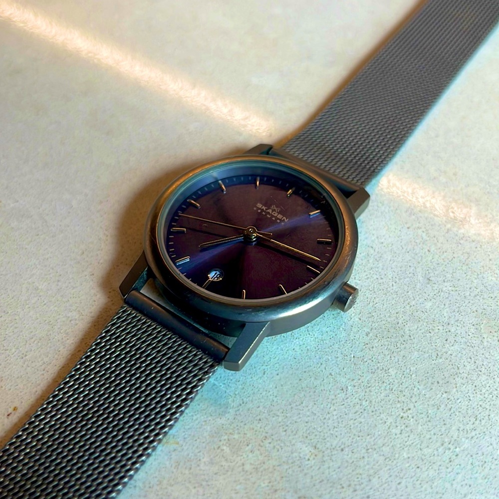 A Skagen watch with stainless steal and a beautiful dark purple color.